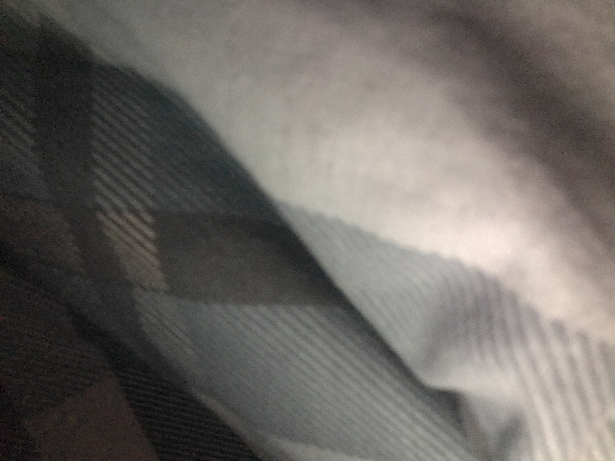 The image shows a close-up of a gray and black striped fabric. The fabric is textured with thin, parallel lines that alternate in shade. The folds of the fabric create areas of light and shadow. The location in Yerevan, Armenia is not discernible from the image.