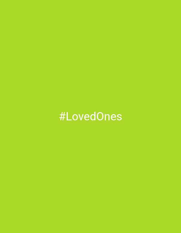 The image features a simple graphic with a plain, solid bright lime green background. Centered on this background is the white text "#LovedOnes", rendered in a clear, sans-serif typeface. No other subjects, objects, or activities are depicted. The scene is devoid of any specific location cues, time of day indicators, or weather conditions. Based on the provided context, the image is associated with Chaikovsky, Russia.