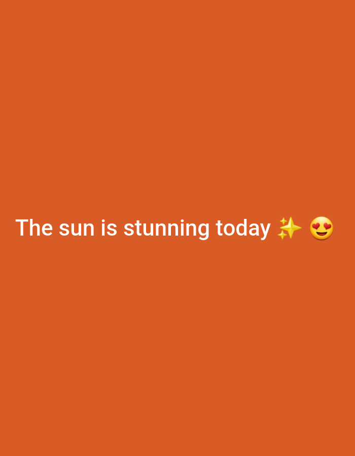 The image is a digital graphic with a plain orange background. White text overlaid on the bottom reads, "The sun is stunning today". To the right of the text are two emojis: a yellow star and a yellow face with heart-shaped eyes. There are no people, objects, or scenery present in the image. The location in the city of Gwagwada, Nigeria is not discernable from the image.