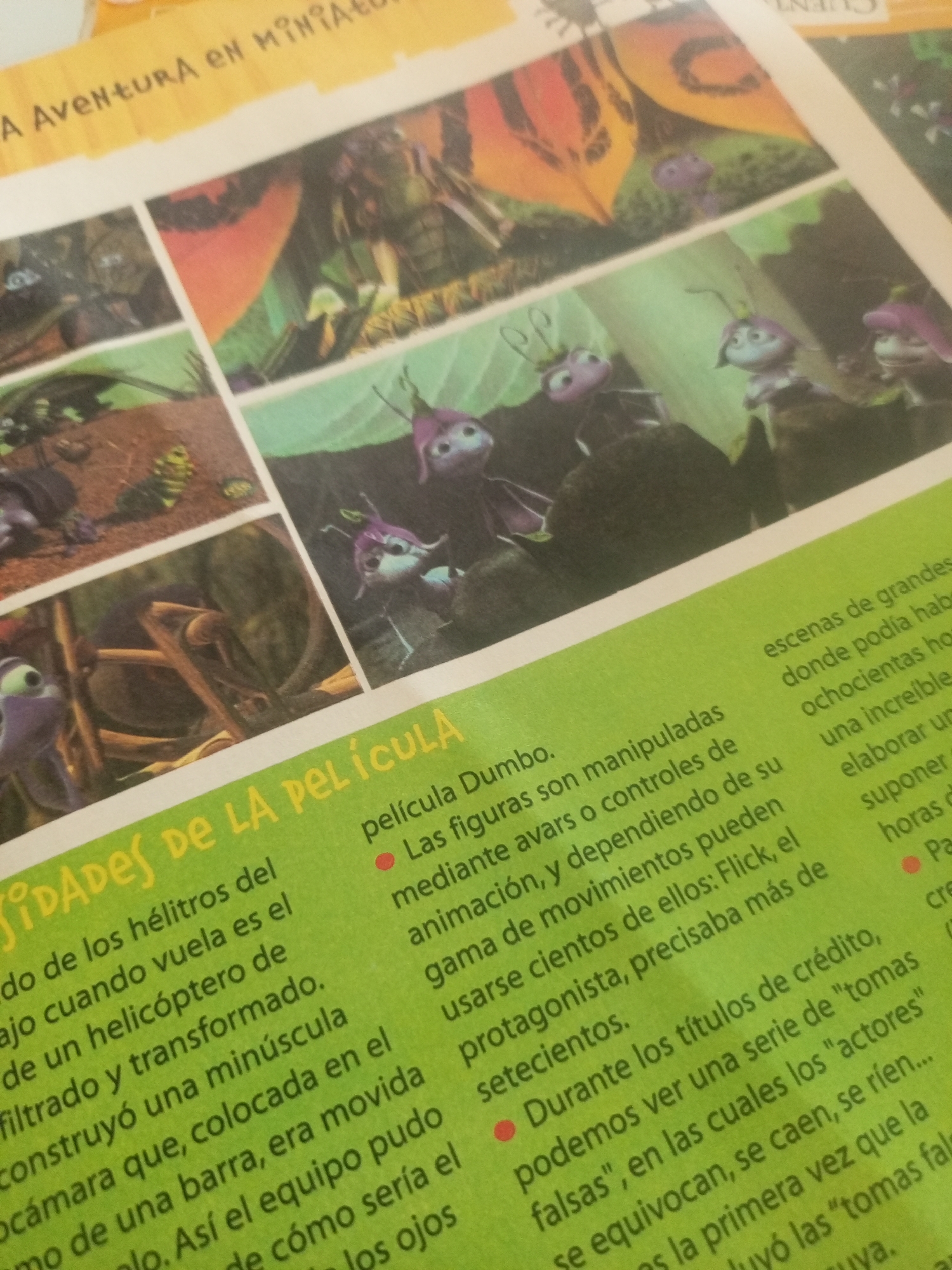 The image shows a close-up of a magazine page with colorful illustrations and text. The text is in Spanish and appears to be discussing a movie or animated film, possibly related to insects or small creatures. One section of the text mentions "película Dumbo," indicating a connection to the movie Dumbo. Another section talks about "figuras" (figures) and "animación" (animation). There is no information about the location of La Tagua, Venezuela, in the image.