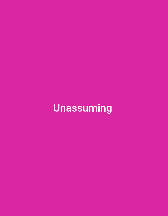 The image is a solid magenta background with the word "Unassuming" written in white text centered on the lower half of the frame. There is no discernible location in the city of Anilelerin, Nigeria, or any other geographical markers. The image contains no people, subjects, objects, actions, interactions, or environmental details.