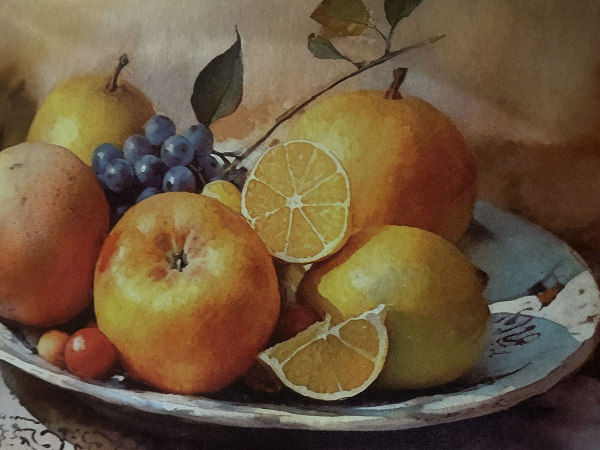 The image is a still life watercolor painting of a fruit assortment in a metal bowl. The fruits include apples, pears, grapes, oranges, and what appears to be a lemon slice. The background is a muted, textured surface. There are no people or animals depicted, and no discernible urban environment. The painting's style is realistic, with soft brushstrokes and subtle color blending. The lighting suggests a gentle, diffused light source, highlighting the textures and forms of the fruit. The composition is balanced, with the fruits arranged artfully within the bowl. The overall mood is serene and classical.