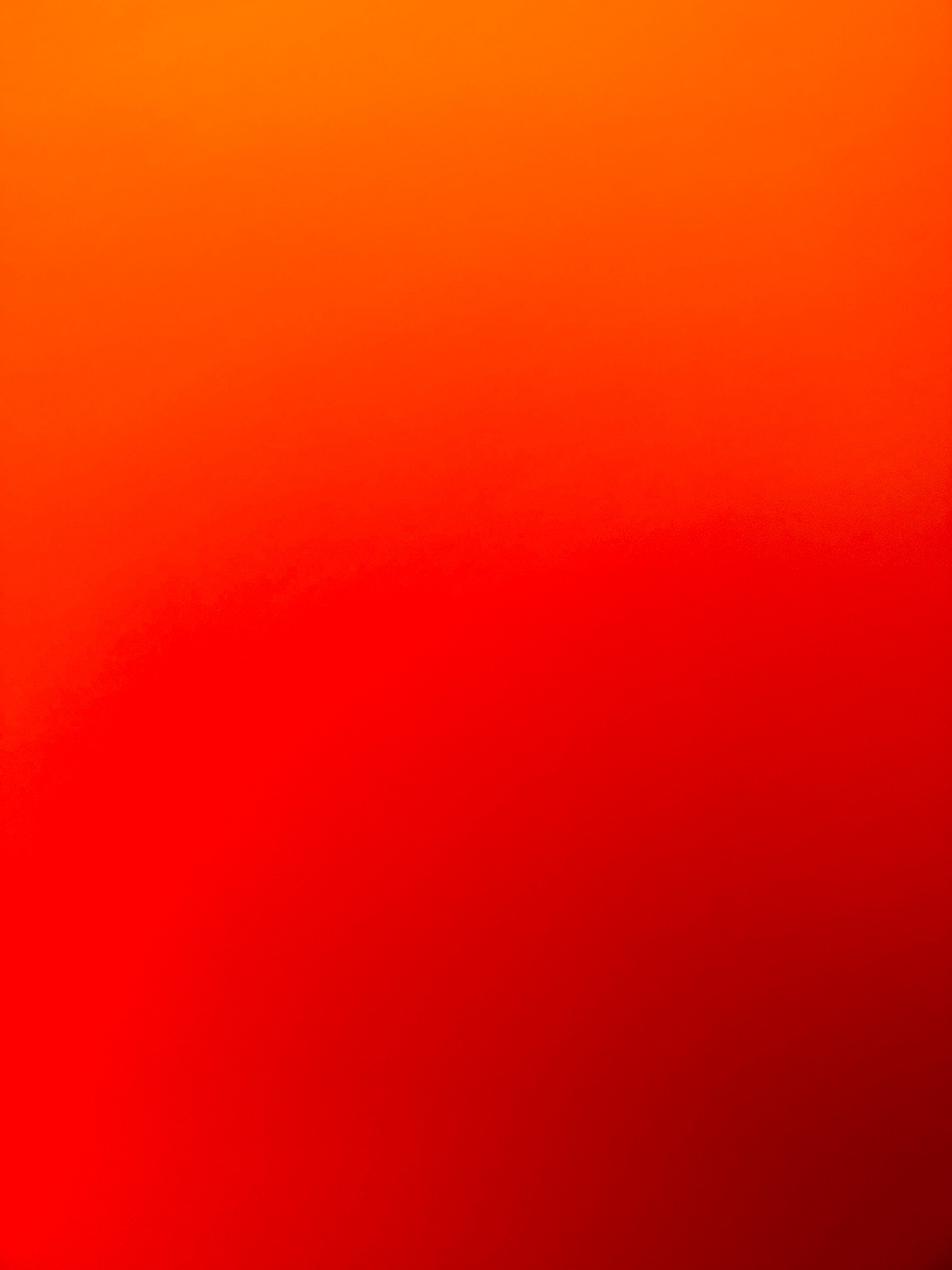 The image is a gradient of red and orange colors, fading from orange at the top to a deep red at the bottom. There are no discernible objects, people, or environmental features present in the image. The location in the city of Zavolzhye, Russia is not ascertainable from the provided image.