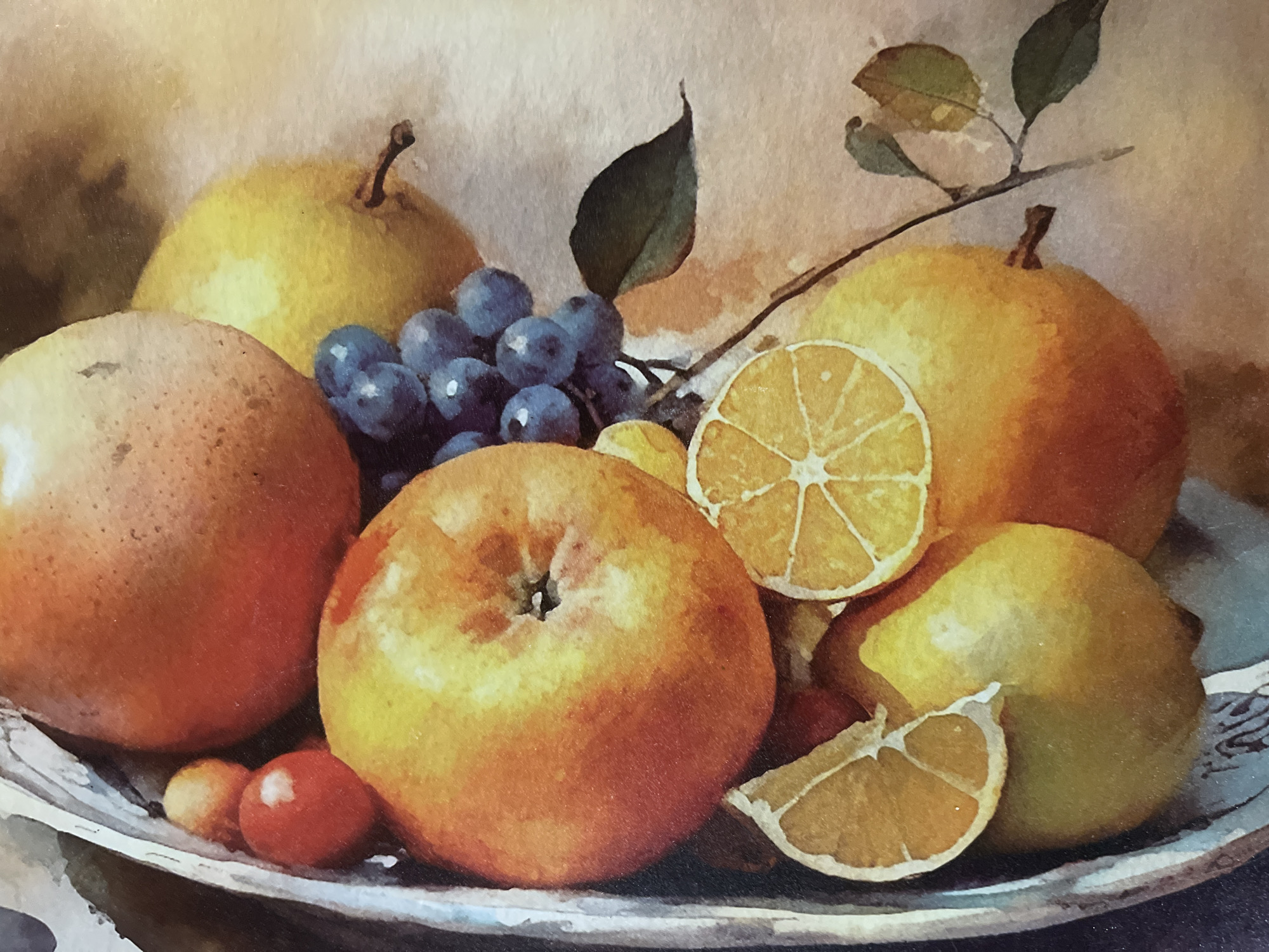 This is a watercolor painting of a still life arrangement of various fruits in a metal bowl. The fruits include an apple, a pear, grapes, oranges, and what appear to be two small tomatoes. There are also slices of citrus fruit, possibly lemon or orange, and some leaves and a stem. The background is a muted, textured color, suggesting a light-colored surface. The painting exhibits soft edges and a luminous quality characteristic of watercolor. There is no indication of any specific city or location, including Minsk, Belarus.