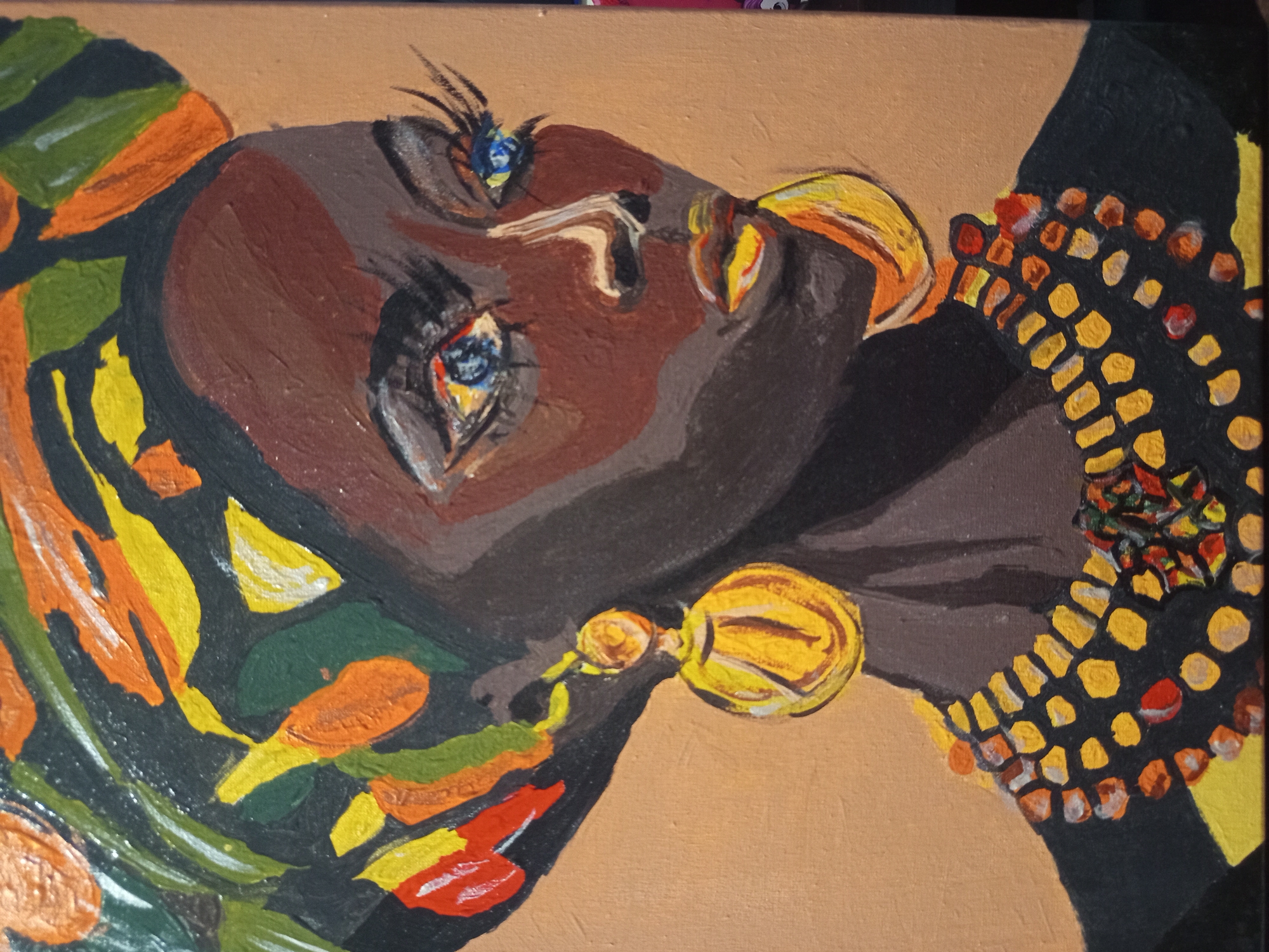 This is a painting of a woman wearing a colorful headwrap, large golden earrings, and a beaded necklace. She has dark skin, bright blue eyes, and red and yellow lips. The background is a solid tan color. There is no visible information about the location in the city of Чэрвеньскі сельскі Савет, Belarus.