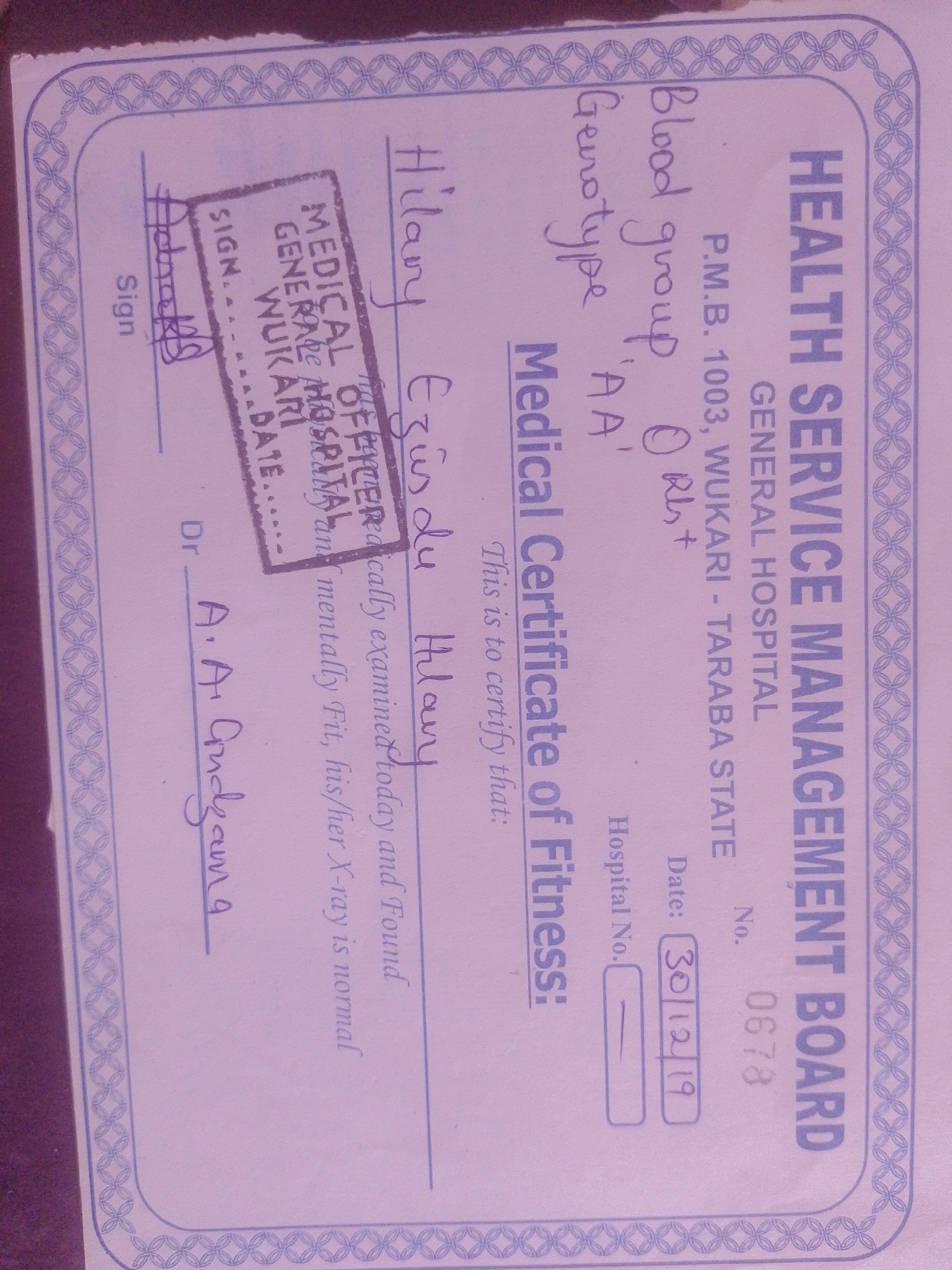 This media file appears to be a medical certificate of fitness, likely issued in Nigeria, specifically referencing "Magajin Gari" and "Wukari - Taraba State". The certificate is for an individual named Hilary Ezüsdu Hilary, whose blood group is O+ and genotype is 'AA'. The document details that the individual was medically examined on December 30, 2019, and found to be physically and mentally fit, with normal X-ray results.
The certificate features printed text from the "HEALTH SERVICE MANAGEMENT BOARD" and "GENERAL HOSPITAL", along with handwritten entries. Key handwritten details include the individual's name, blood group, genotype, and the date of examination. There's a space for a signature and a "Sign" field, along with a stamp from "MEDICAL OFFICER, GENERAL HOSPITAL WUKARI". Another signature from "Dr. A. A. Andzama" is also present.
The overall impression is a formal document confirming an individual's health status for a specific purpose, possibly employment or travel. The presence of official stamps and signatures suggests a legitimate medical assessment.
