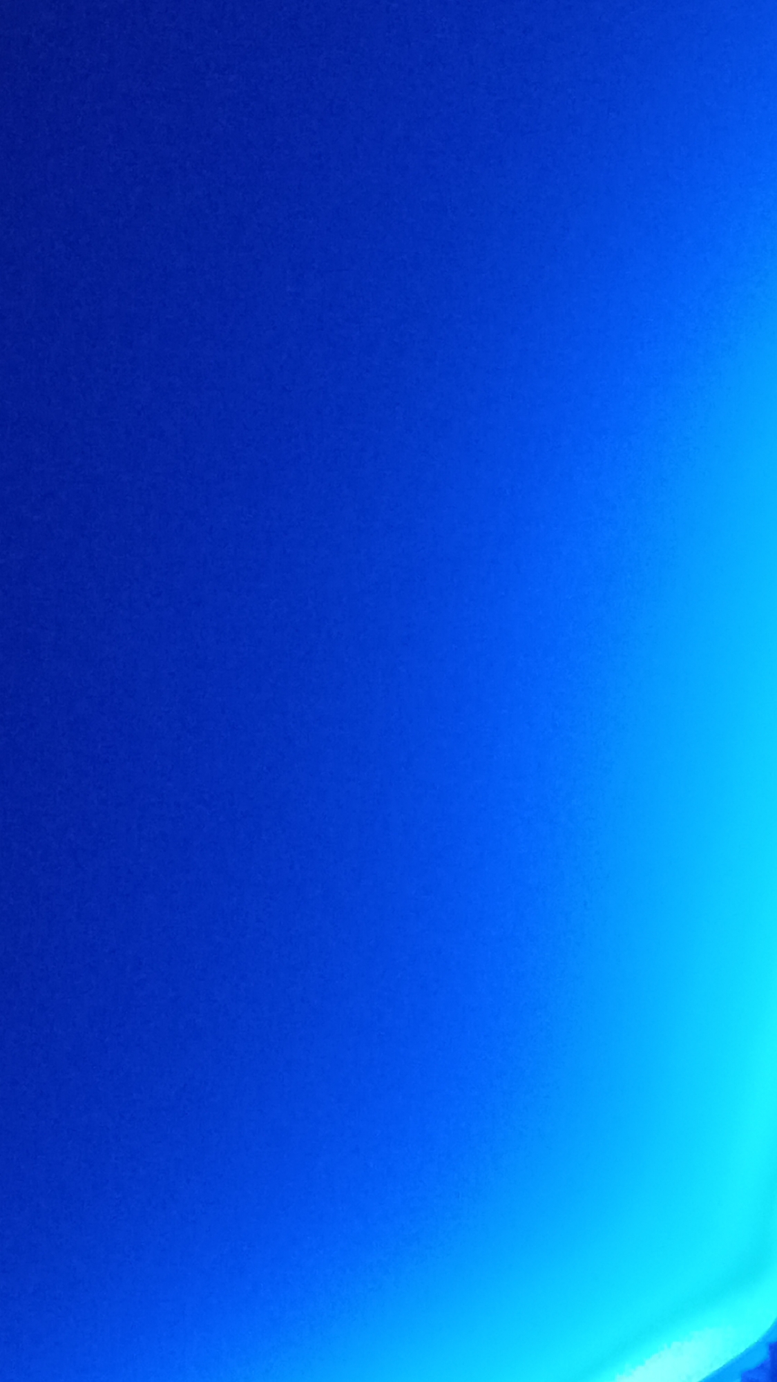 The image is an abstract photograph of a gradient of blue light, transitioning from a deep navy blue on the left to a bright cyan on the right. There are no discernible objects, people, or environmental features present that would indicate a specific location in the city of Zvenigorod, Russia, or anywhere else. The image appears to be purely an aesthetic study of color and light.