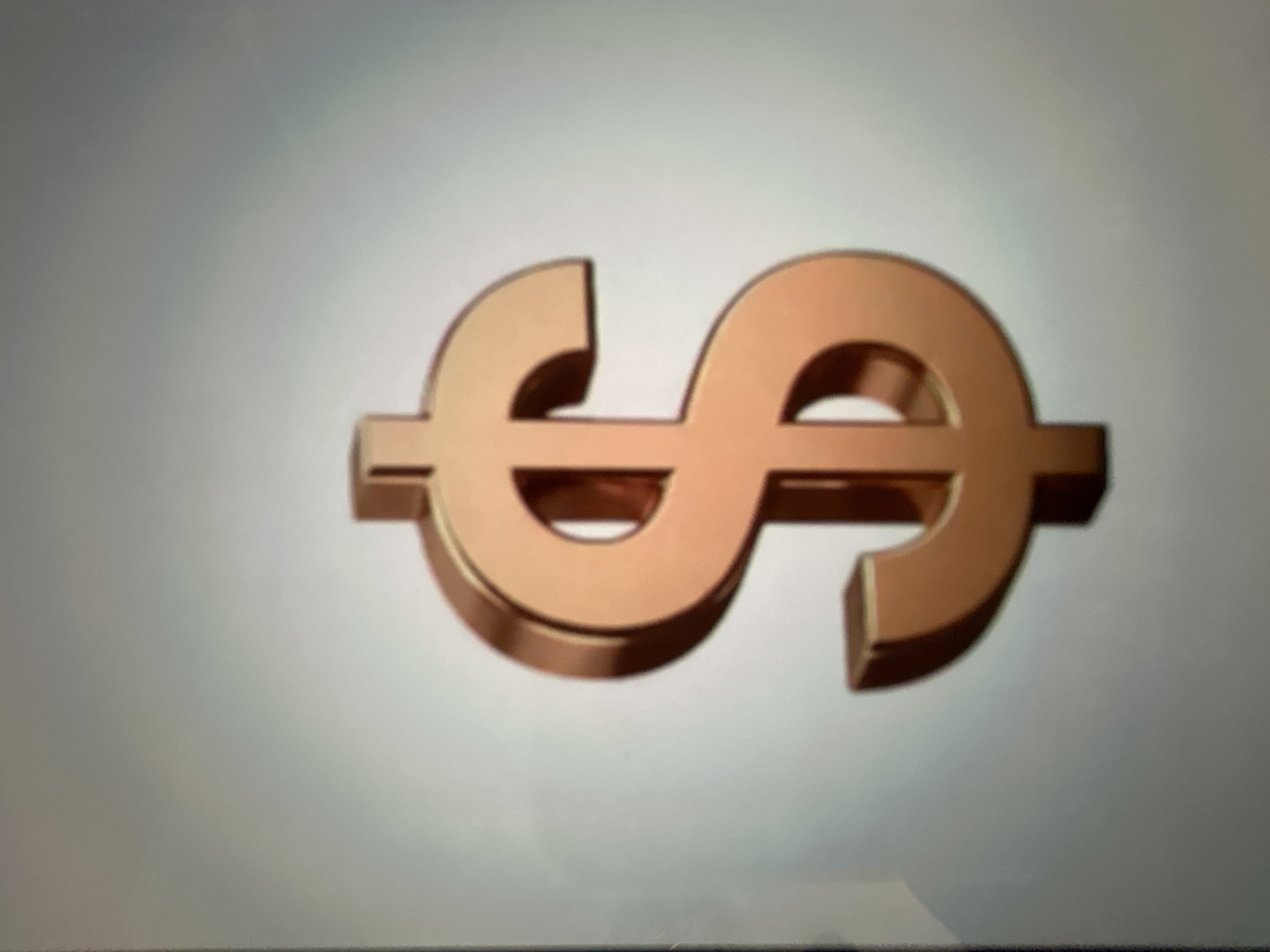 The image displays a 3D rendered copper-colored dollar sign against a gradient gray background. There is no discernible location in the city of Gelendzhik, Russia, as the image is a digital graphic and not a photograph of a real-world scene.