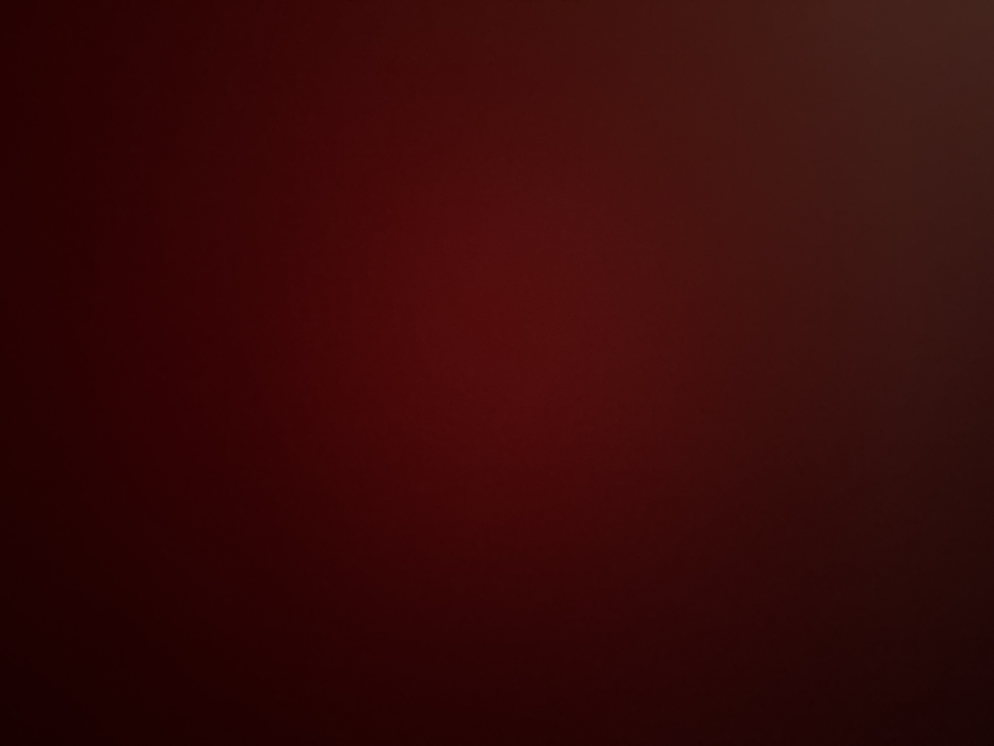 This is a still image that appears to be a photograph of a dark, reddish-brown surface. The lighting is dim and uneven, with a gradient of color that is darker at the top and lighter towards the bottom right. There are no discernible objects, people, actions, interactions, or environmental features visible in the image. The image is abstract and lacks any specific context or identifiable content. Without further information or context, it is impossible to determine the location in Varna, Bulgaria, or any other details about the scene.