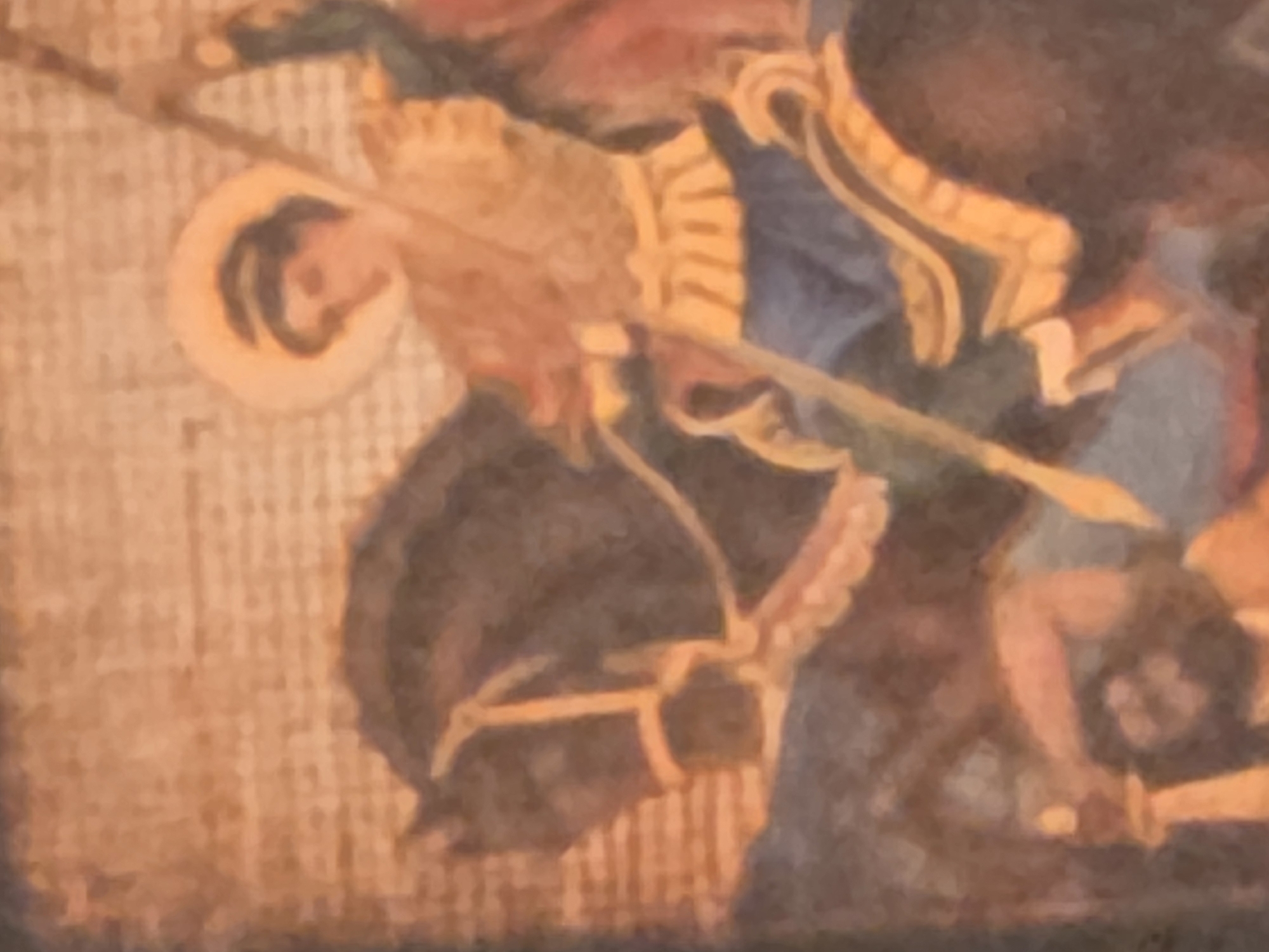 The image shows a portion of a painting, possibly a mural or fresco. The subject appears to be a knight on horseback, identifiable by the gold-trimmed blue clothing, a possible halo, and a spear or lance aimed downwards. The horse is dark, and the knight's target seems to be a figure on the ground holding what may be a sword. The background is a textured surface, possibly a wall. The location is unknown.