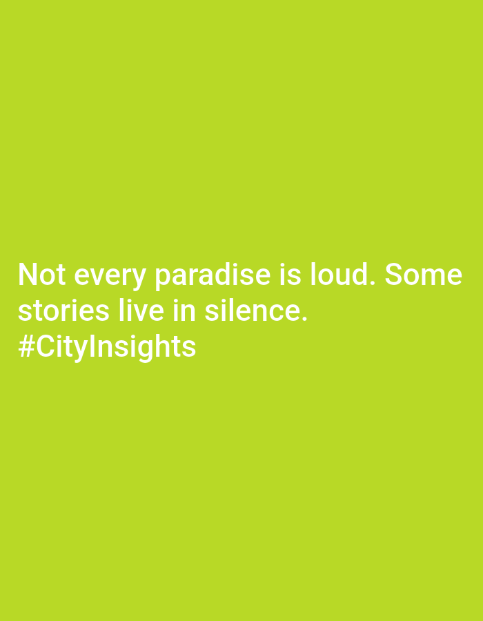 The image consists of white text on a green background. The text reads "Not every paradise is loud. Some stories live in silence. #CityInsights". The scene suggests a reflection on the nature of paradise and stories within an urban context, potentially in Hua Hin City Municipality, Thailand, as indicated by the hashtag.