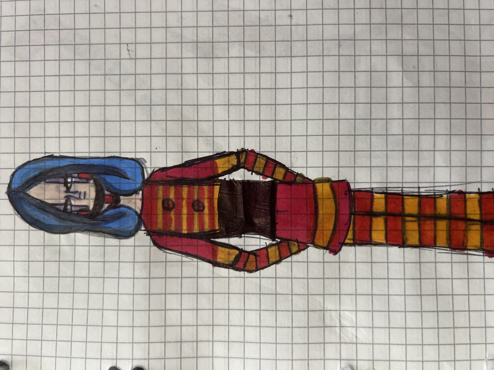 A full-body, front-facing drawing of a stylized puppet character is depicted on graph paper. The character has bright blue hair that frames a pale face with sharp, dark eyebrows, closed eyes with dark eyeliner, and prominent dark vertical lines under each eye. A dark line extends down from the chin, suggesting a mouth or a jawline detail. The puppet's body is clad in a vibrant outfit with alternating horizontal stripes of red and yellow. This striped pattern extends from the shoulders down to the hands and legs. A dark brown sash or belt cinches the waist, and two circular, dark brown buttons are visible on the upper chest. The lower half of the outfit consists of striped pants that extend to the feet. The puppet's hands are tucked into the front pockets of its pants, and its stance is upright. The background consists of a grid pattern of light gray lines, characteristic of graph paper. There is no discernible location in the city of Minsk, Belarus, or any environmental context outside of the graph paper medium.