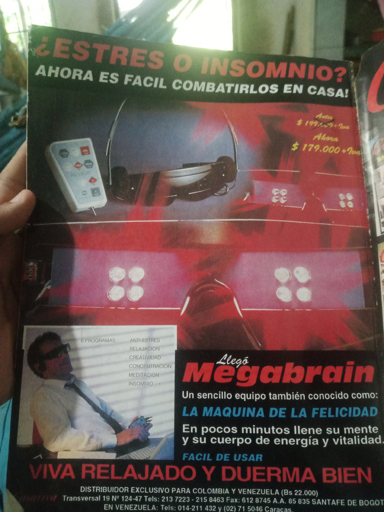 The image is a photograph of a magazine advertisement. The advertisement is for a product called "Megabrain" and claims to help combat stress and insomnia. The ad features an image of a man wearing headphones and sunglasses, sitting at a laptop, with a remote control in his hand. The text of the advertisement is primarily in Spanish. It provides pricing information in Bolivars (Bs.) and contact details for distributors in Colombia and Venezuela, including a telephone number for Caracas, Venezuela. There is no indication of Santa Ana, Venezuela, in the provided text. The background of the advertisement is predominantly red and black.