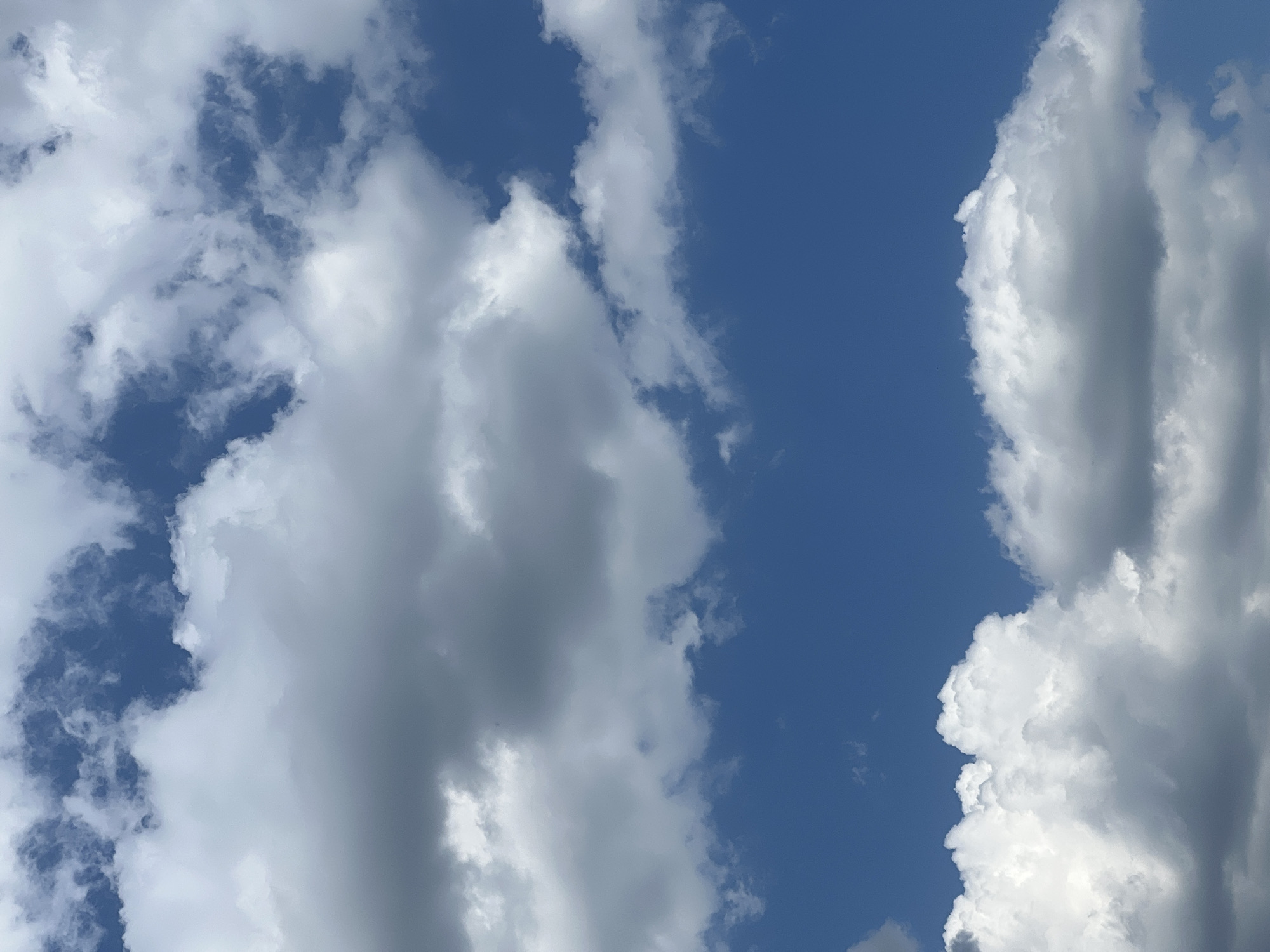 The image shows a blue sky with several white and gray clouds. The clouds are scattered throughout the sky, with some appearing more dense and fluffy than others. There are no people, buildings, or other objects visible in the image. The location is given as Sorochinsk, Russia, but this information cannot be verified from the image itself.