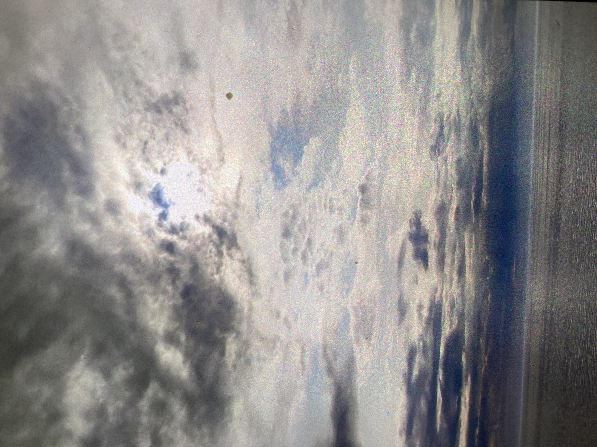 The image shows a sky with clouds, potentially a body of water on the right. It is difficult to definitively identify the location as Saint Petersburg, Russia, without more context.