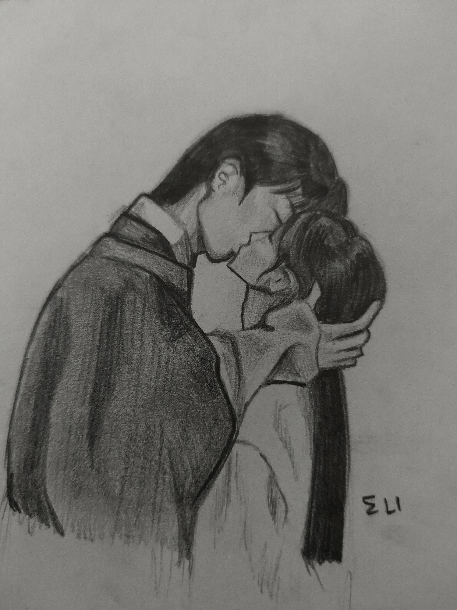 The image is a monochrome pencil drawing depicting two individuals in an intimate embrace, appearing to be kissing. The drawing is rendered on a light grey background, devoid of any environmental details or setting.
The figure on the left, seemingly taller, is depicted with long, dark hair styled back. This individual wears a dark, long-sleeved garment, possibly a traditional robe or coat, featuring a visible lighter collar underneath. Their head is tilted downwards, eyes closed or nearly closed, and their face is in close proximity to the other figure's.
The figure on the right, appearing slightly shorter, wears a lighter-toned garment. This individual also has dark hair, styled in a manner that suggests it might be pulled back or in a bun. Their head is tilted upwards towards the left figure, with eyes also closed or nearly closed. Their left hand (viewer's right) is positioned on the back of their own head or the back of the left figure's head, gently cupping or grasping the hair.
Both figures' lips are either touching or in very close proximity, indicating a tender and affectionate interaction. The overall composition shows their upper torsos and heads, with the lower parts of their bodies cropped out of view.
In the lower right corner of the drawing, oriented vertically, are the letters "ELI" followed by the numbers "173," which appear to be a signature or mark.
There are no visual cues or contextual elements within the drawing to suggest a specific real-world location, such as Davao City, Philippines, or any other geographical setting.