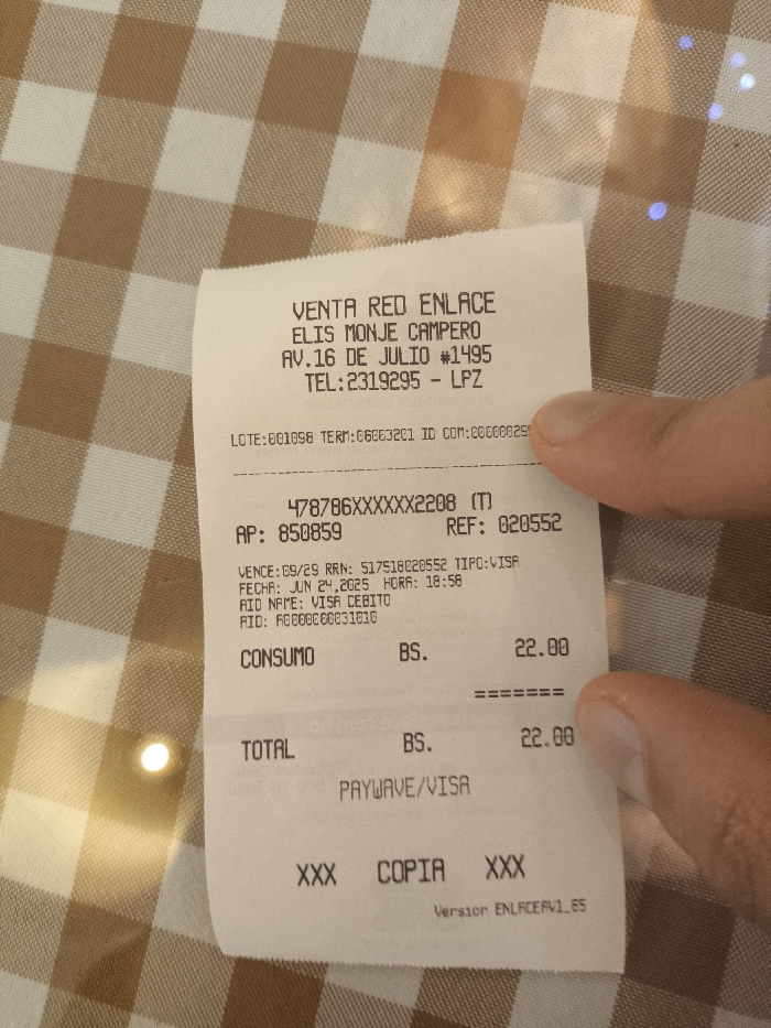 The image displays a sales receipt from Venta Red Enlace, specifically Elis Monje Campero located at Av.16 de Julio #1495 in LPZ, with the phone number 2319295. The transaction details include a card number 478786XXXXXX2208, AP 850859, REF 020552, expiration date of 09/29, and a transaction date of June 24, 2025, at 18:58. The purchase, labeled "CONSUMO," is 22.00 BS, which is also the total. The payment method was PayWave/Visa using a Visa Cebito card. The receipt is marked "COPIA".