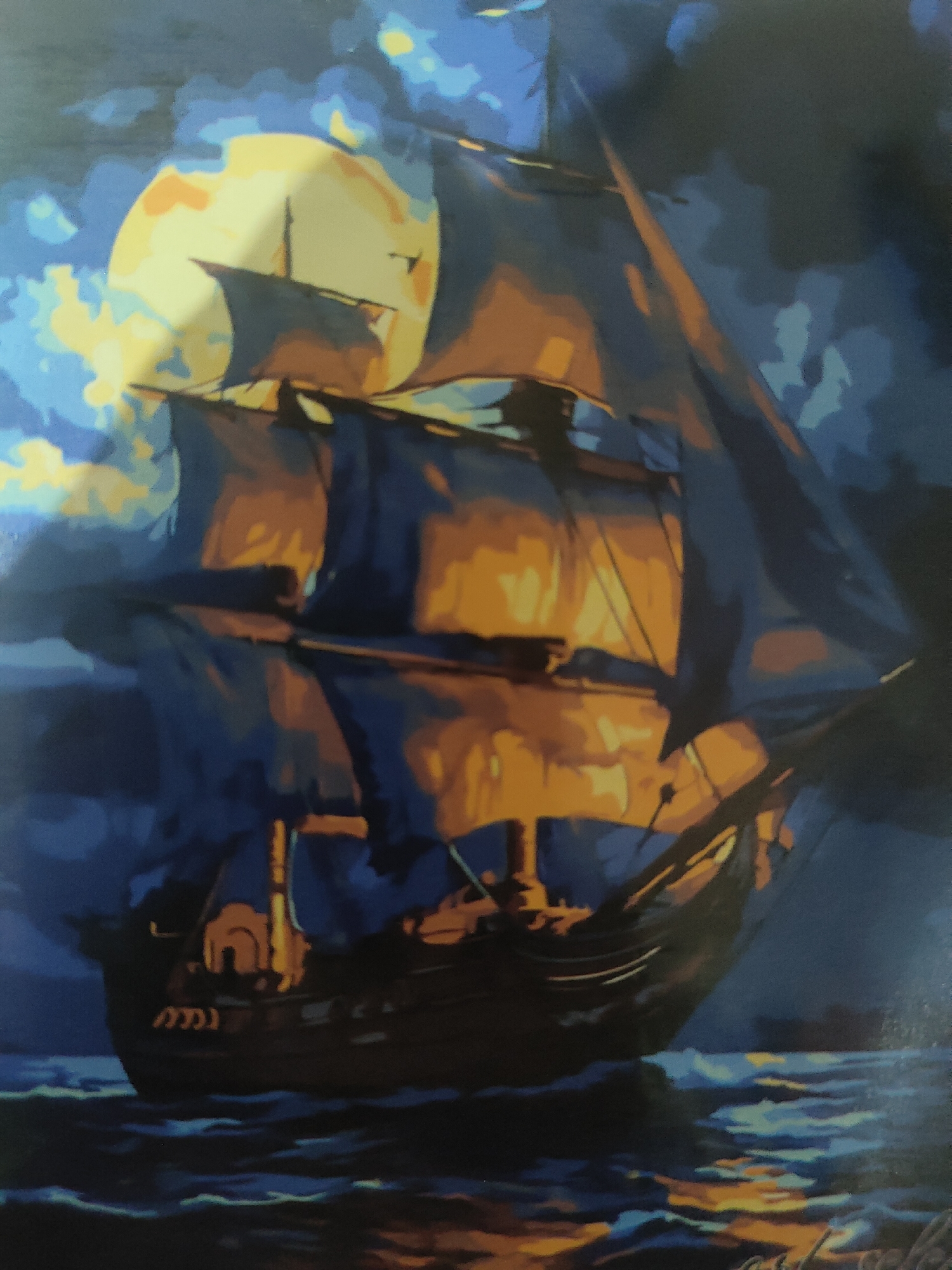 The image depicts a painting of a tall ship sailing on the ocean under a full moon. The ship has dark sails that are illuminated by the moonlight, casting an orange glow. The moon itself is large and yellow, surrounded by dark, cloudy skies. The water is dark and choppy, with reflections of the moonlight and the ship. The style of the painting is impressionistic, with bold brushstrokes and a focus on color and light. There are no people visible in the painting, and no indication of a specific location in Ternovka, Moldova.