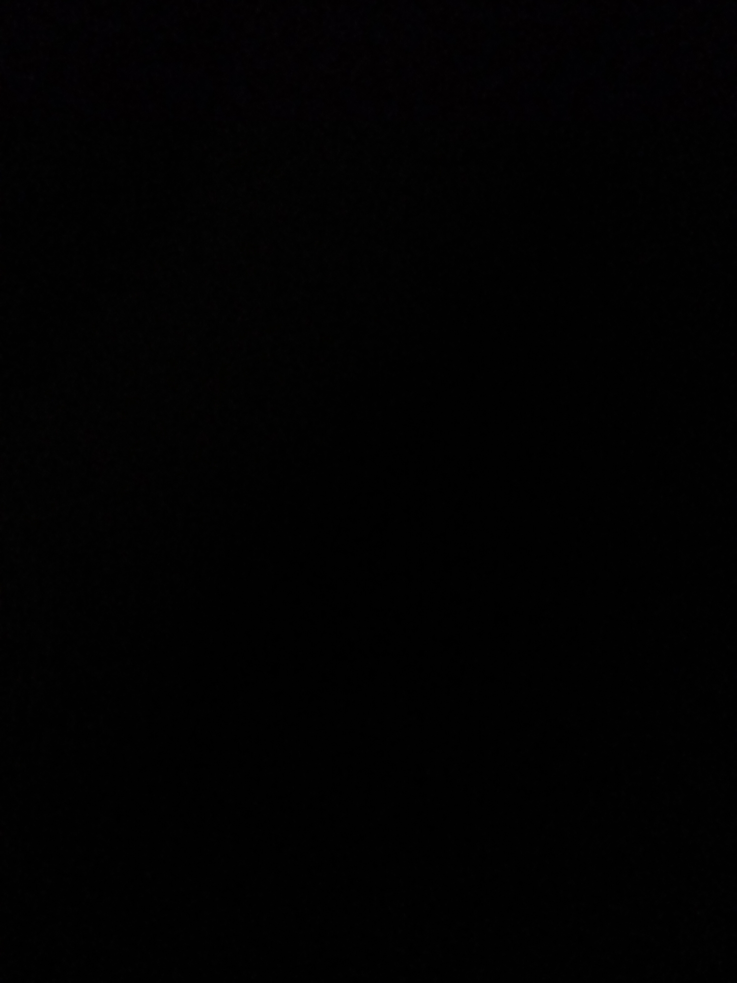 The image is a black square with no discernible subjects, activity, or details. It is impossible to determine any of the requested information, including location context, time of day, weather, emotions, or visible text, from the provided media file.