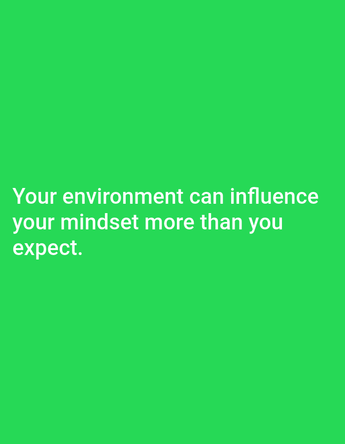 This is a medium shot of a white text quote superimposed on a vibrant green background. The quote, "Your environment can influence your mindset more than you expect," is centered on the lower half of the image and is written in a sans-serif font. There are no people, objects, or actions visible in the image. The background is a solid, uniform green with no discernible features. The image is a graphic with text, not a photograph of a real-world scene. There is no information within the image to suggest a location in Tebuwung, Indonesia, or any other geographical context.