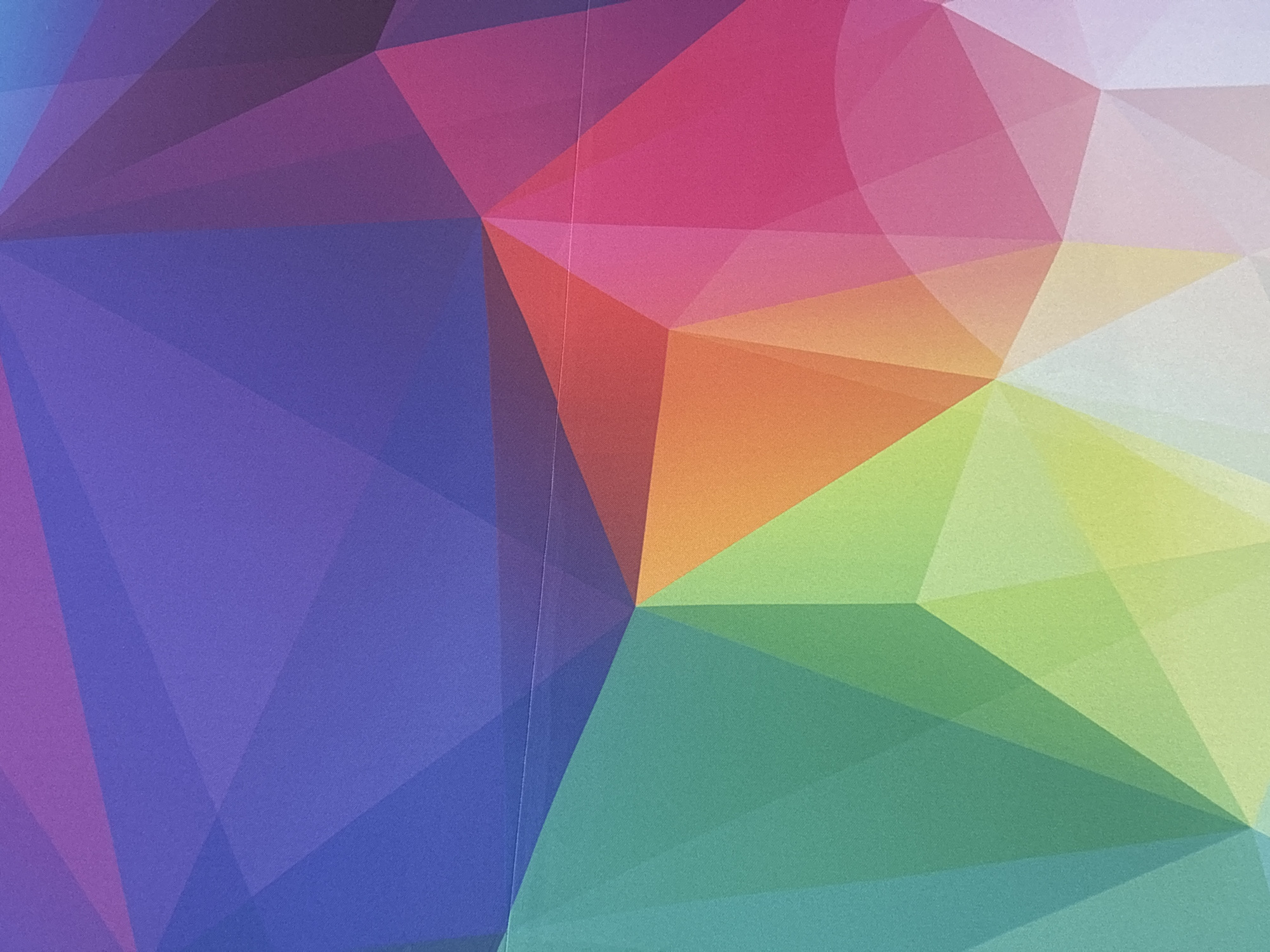 The image shows an abstract geometric pattern with triangles and polygons in a variety of colors, including purple, blue, red, orange, green, and white. The colors blend and overlap, creating a sense of depth and dimension. There is no indication of location, people, subjects, objects, actions, or interactions in the city of Buenavista, Mexico.
