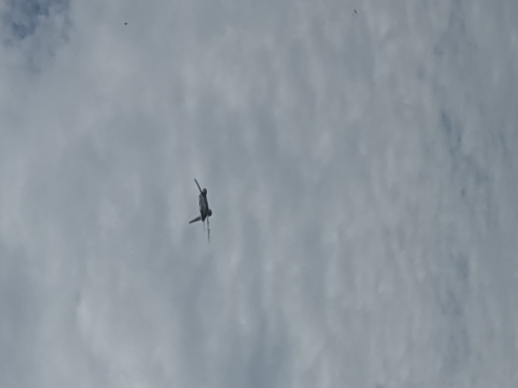 An aircraft is in flight against a cloudy sky. It is not possible to determine the specific type of aircraft from this image. The location is unknown, and there is insufficient detail to verify the city of บ้านบางรักษ์, Thailand.