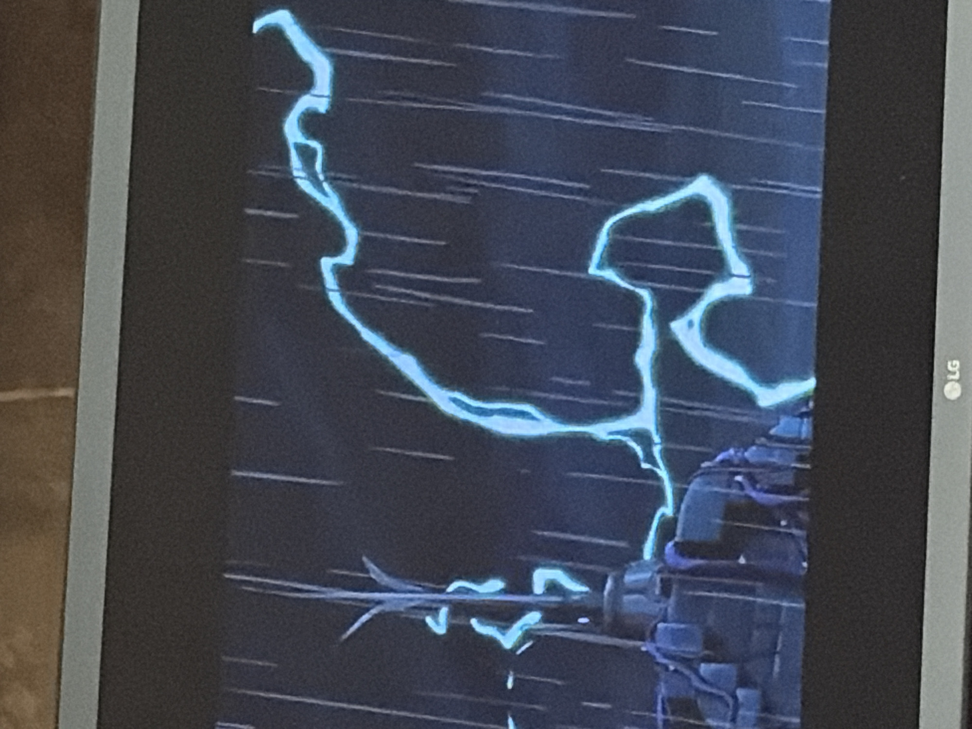 The image shows a stylized, animated depiction of a thunderstorm. In the foreground, a dark, angular structure, possibly a tower or building, is visible on the left. A bright blue lightning bolt arcs across the dark, rainy sky behind the structure. Thin, white lines represent the falling rain. The overall scene is dark and dramatic, with the lightning providing the primary source of light. There are no people visible in the image.