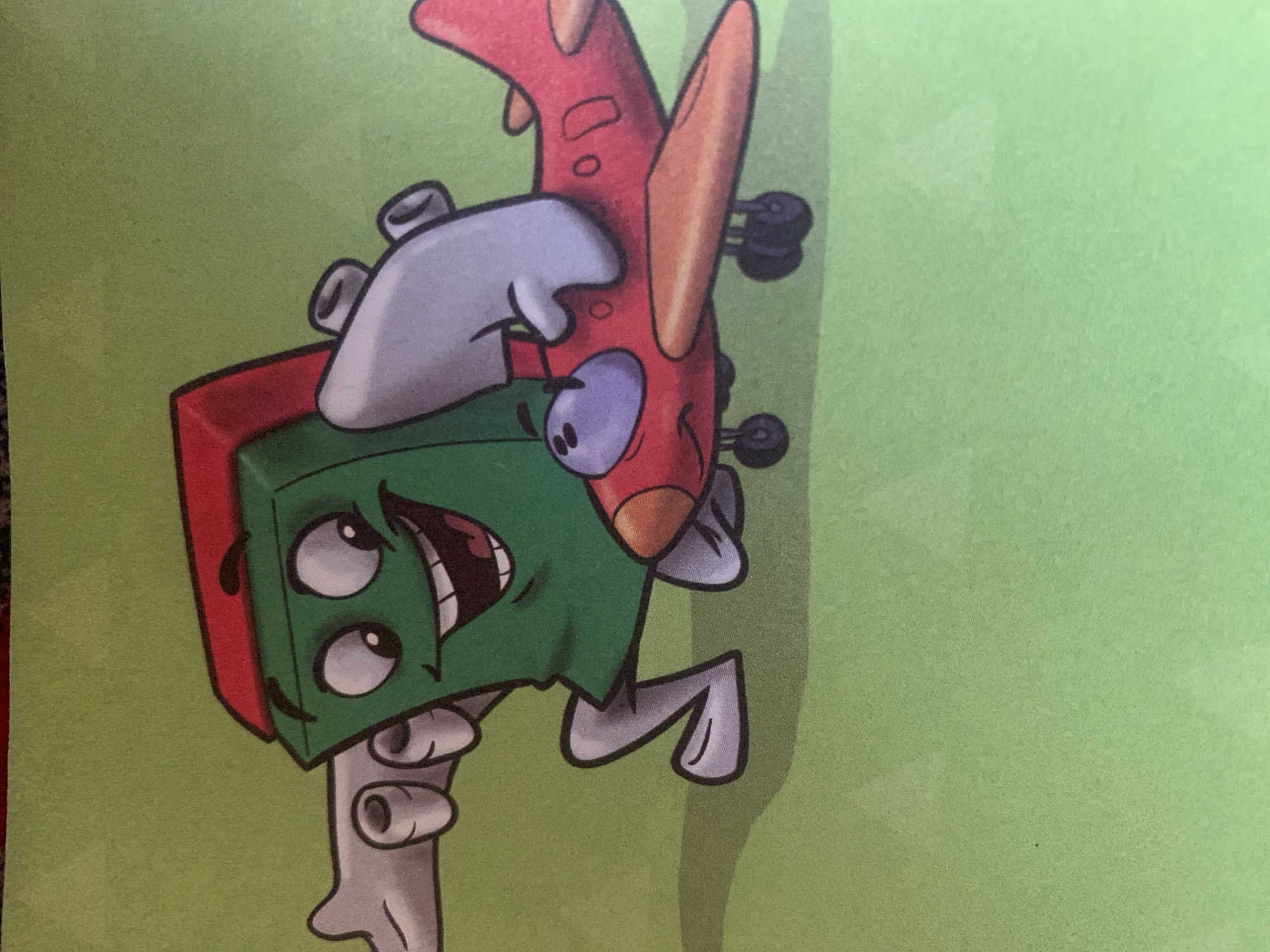 The image shows a cartoon illustration of a green rectangular character with a red top, wearing grey gloves and shoes. The character is smiling widely and has two large eyes. It is holding onto the wing of a small red airplane, which also has a cartoon face. The airplane has purple windows and orange accents on its wings and propeller. The background is a plain light green color. The image is a drawing and does not depict any real-world location, including Jauro Yinu, Nigeria.
