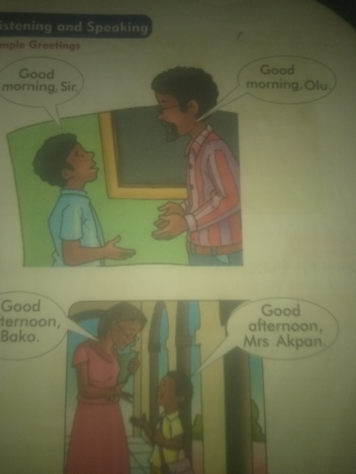 The image depicts two separate scenes, likely from an educational book, illustrating greetings.
The top scene shows two young boys, presumably in Jauro Yinu, Nigeria, engaging in a morning greeting. The boy on the left, wearing a blue shirt, is looking up and speaking, with a speech bubble above him containing the text "Good morning, Sir." The boy on the right, dressed in a striped shirt, is looking down at him, with a speech bubble containing the text "Good morning, Olu." The background appears to be an interior with a framed picture on the wall.
The bottom scene shows an adult woman and a young girl, also likely in Jauro Yinu, Nigeria, exchanging greetings in the afternoon. The woman, wearing a pink dress and glasses, is looking down at the girl, who is wearing a yellow and green outfit. The woman's speech bubble reads "Good afternoon, Bako." The girl's speech bubble reads "Good afternoon, Mrs Akpan." The setting appears to be a corridor or an indoor public space with architectural elements suggesting it could be a school or a community center.