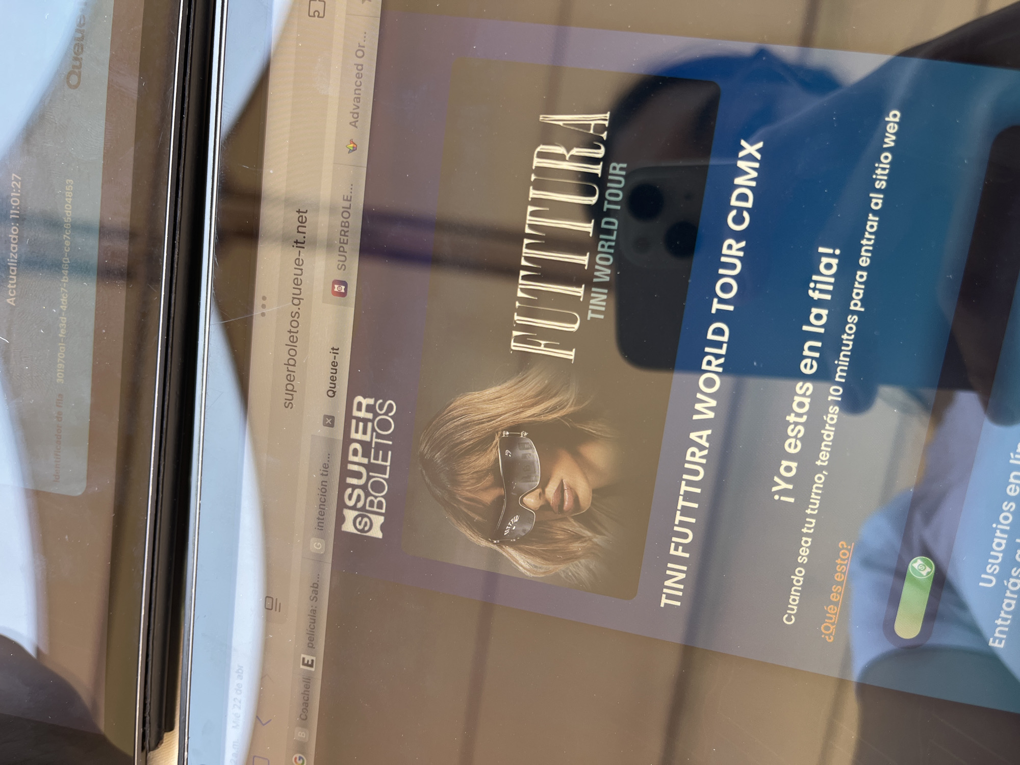 The image shows a tablet displaying a webpage for Superboletos, a ticket-selling platform, in a queue for Tini's "Futttura" World Tour in CDMX (Ciudad de México). The webpage indicates the user is in line and will have 10 minutes to enter the website when their turn arrives.