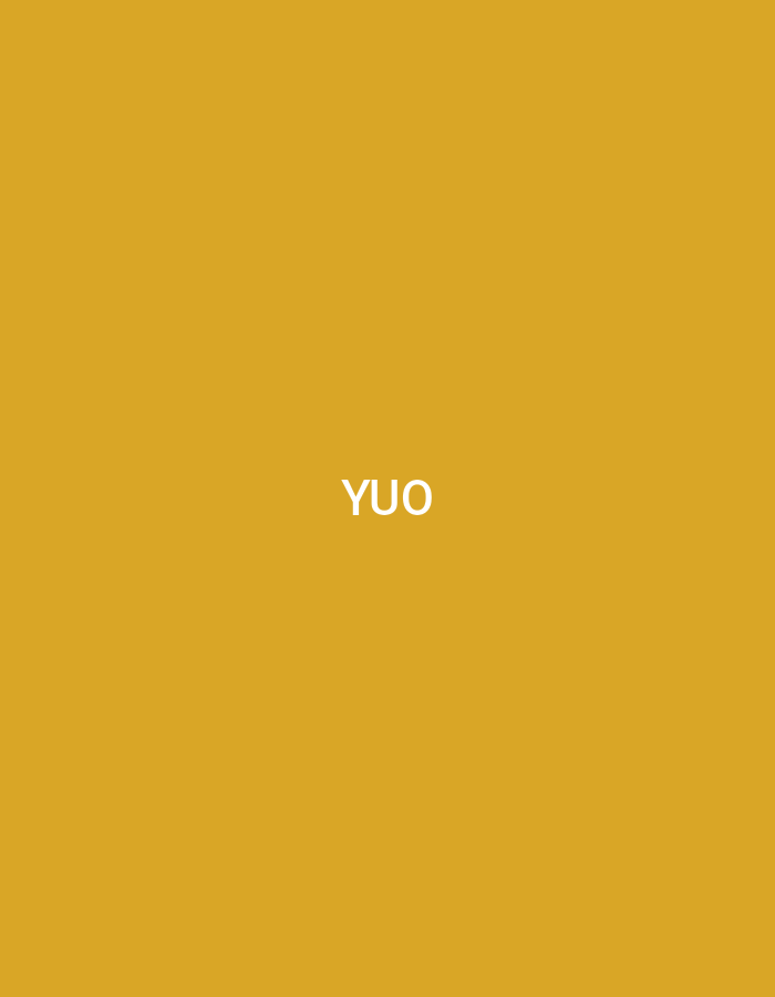 The image displays a uniformly rendered mustard yellow background. Centrally positioned, the white, uppercase text "YUO" is prominently displayed in a sans-serif typeface. This graphic element, a a textual display, is observed as part of a scene located in the city of Casablanca, Morocco. The scene offers no further visual cues regarding people, additional objects, specific architectural features, or ongoing actions; it is solely composed of the colored background and the central text.