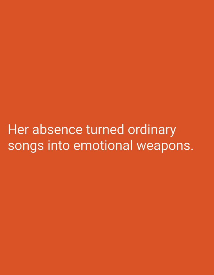 The image is a photograph of white text on an orange background. The text reads: "Her absence turned ordinary songs into emotional weapons." There are no people, objects, or environmental details visible in the image, other than the text and the background color. The location in the city of Lassan, Pakistan, is not evident from the image.