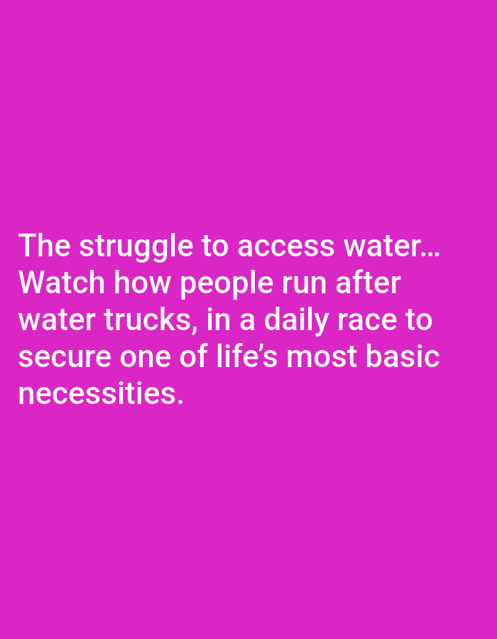 The image is a text overlay on a plain pink background. The text reads: "The struggle to access water... Watch how people run after water trucks, in a daily race to secure one of life's most basic necessities."