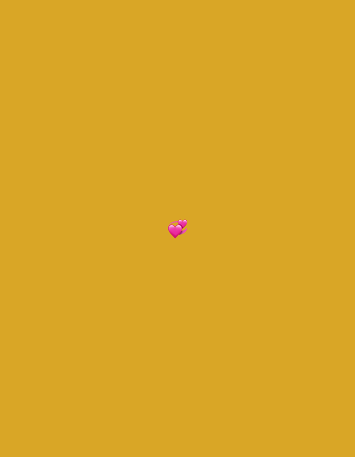 Two small, pink hearts are positioned in the center of the image against a solid, mustard-yellow background. The hearts are slightly overlapping and tilted. There are no other objects or elements visible in the image. The location in Moscow, Russia, is not discernible from the provided image.
