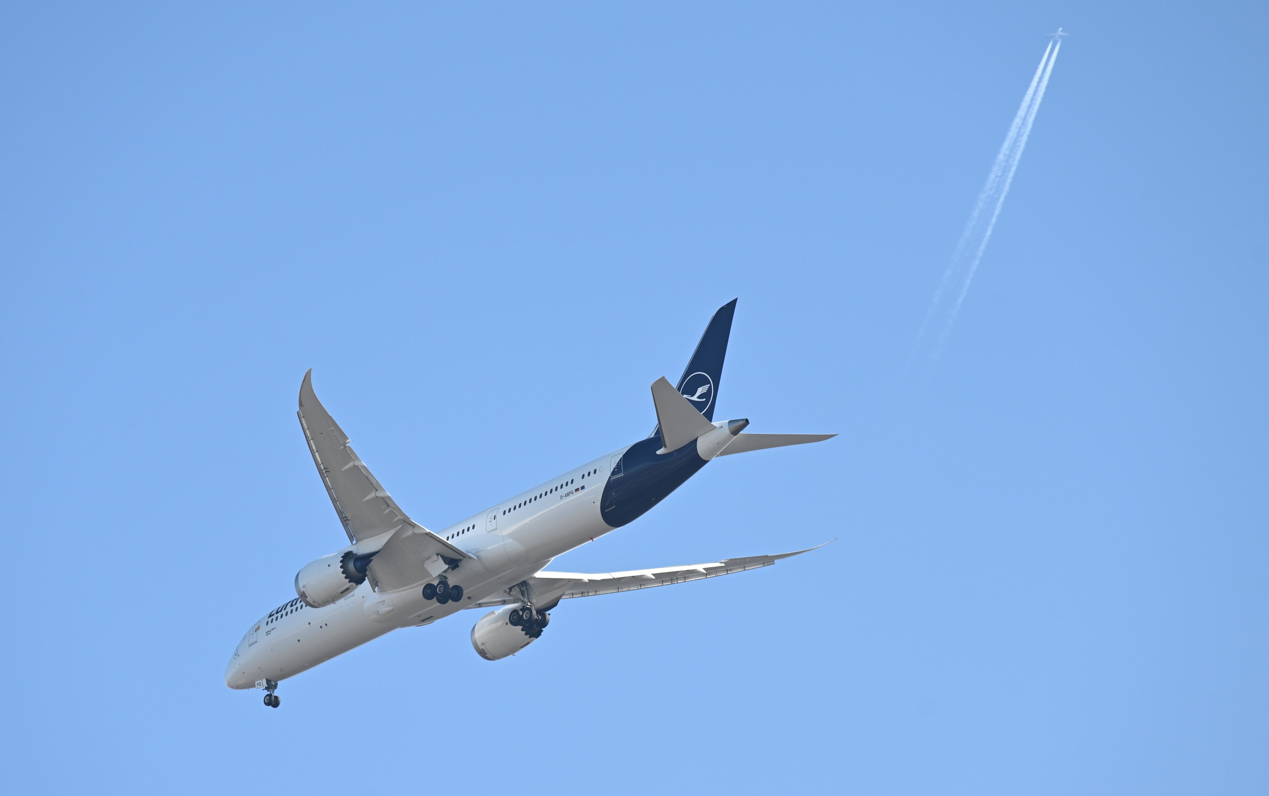 Lufthansa D-ABPQ, a Lufthansa Boeing 787-9 Dreamliner aircraft flying against a clear blue sky