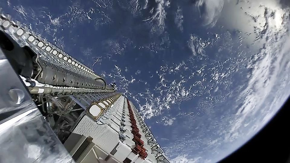 Starlink satellites deploying from a Falcon 9 rocket into Earth's orbit.