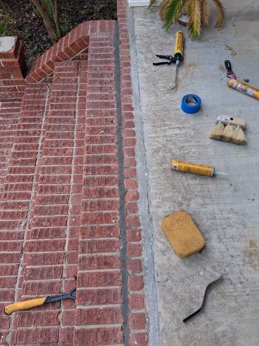 Seal cracks in front porch mortar joints between ports in Madison, MS