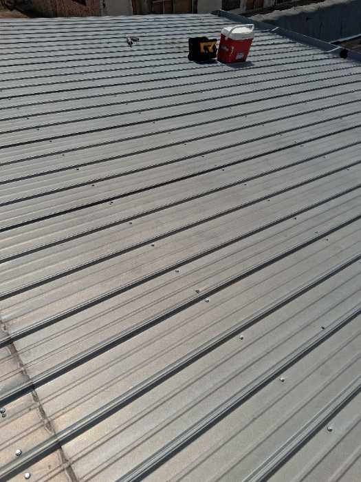 Changed out old screws on metal roof to new better quality bigger screws in Magee, MS
