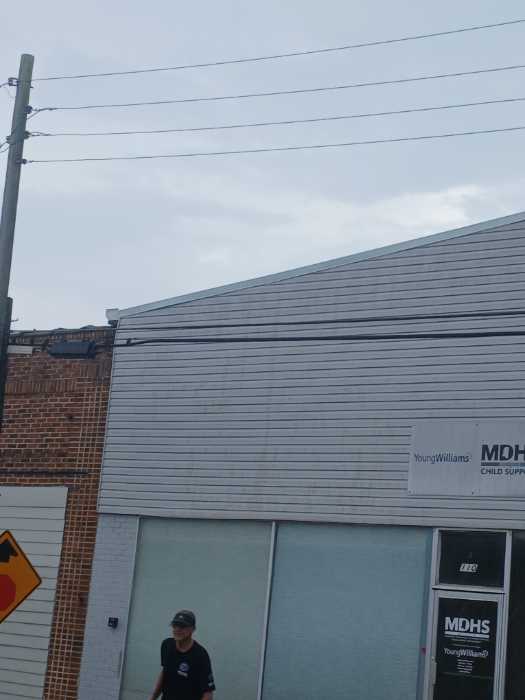 Put gable roof caps on the front and back of the building in Magee, MS