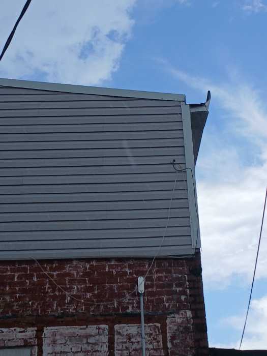 Put gable roof caps on the front and back of the building in Magee, MS, photo 3