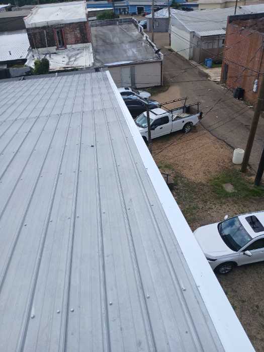 Put gable roof caps on the front and back of the building in Magee, MS, photo 5