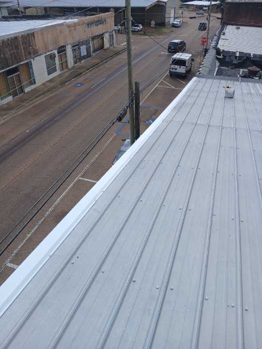 Put gable roof caps on the front and back of the building in Magee, MS, photo 6