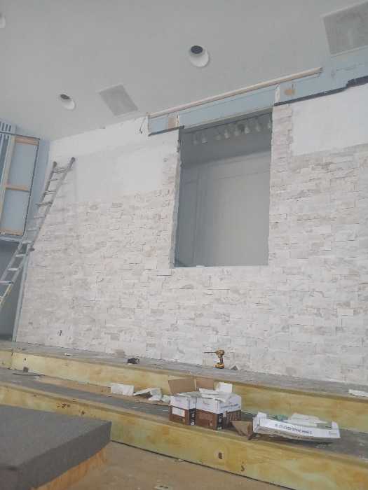 Pulling in stacked stone panels on a wall in Richland, MS