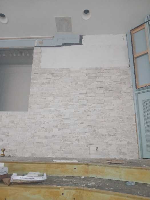 Pulling in stacked stone panels on a wall in Richland, MS, photo 2