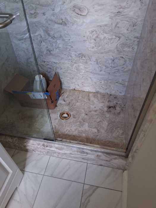 Removing concrete from drain and shower in Pearl, MS