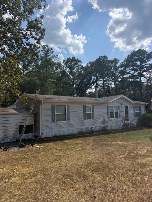 Wind damage on shingle roof removed vent pipe replaced plywood and install new shingles in Florence, MS