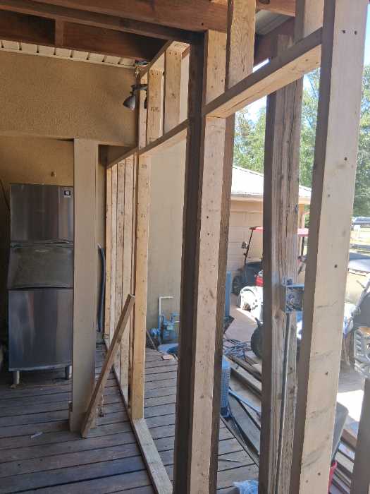 Installing framing on a back deck to turn into a room in Canton, MS