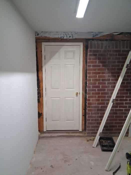 Demo existing wall at door access to garage in Florence, MS