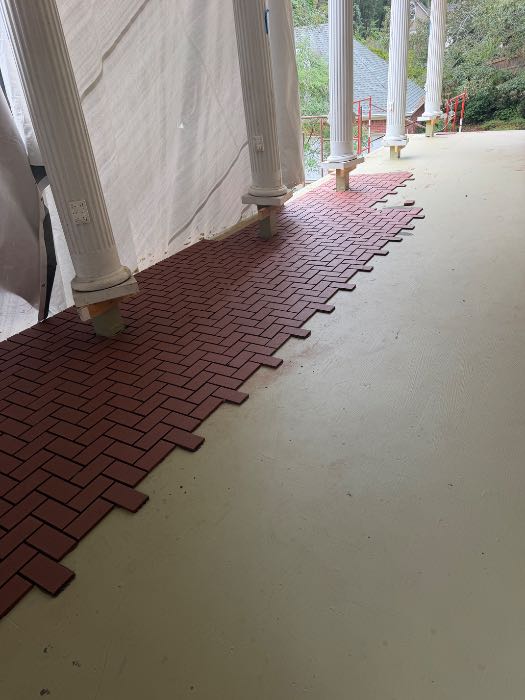 Installing new brick paver floor herringbone in Pearl, MS
