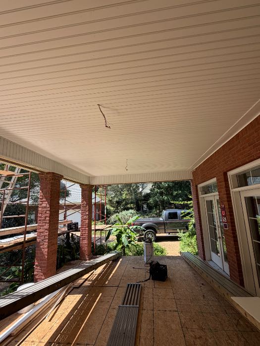 Installing new vinyl under porch ceiling in Pearl, MS